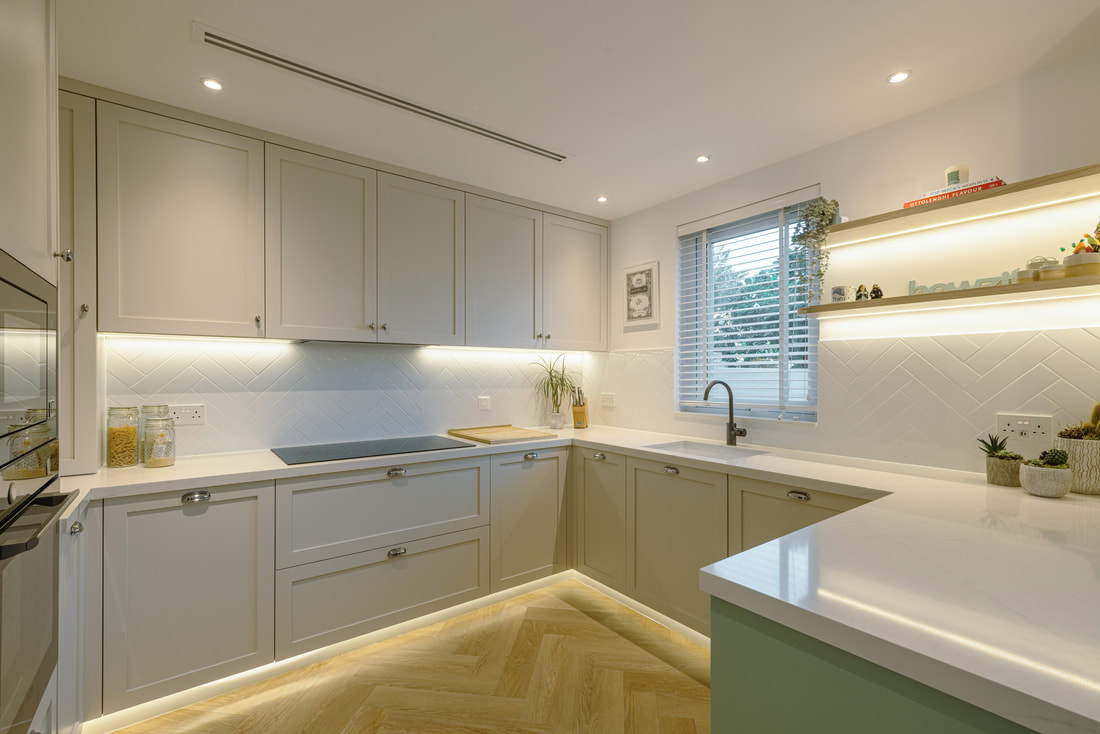 Handmade shaker kitchen in soft sage with quartz worktops and herringbone oak flooring