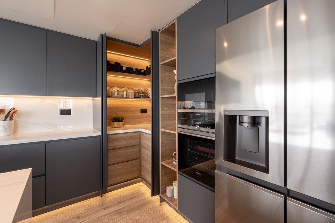 Bespoke graphite kitchen with oak-lined walk-in pantry and integrated appliances in a Dubai villa