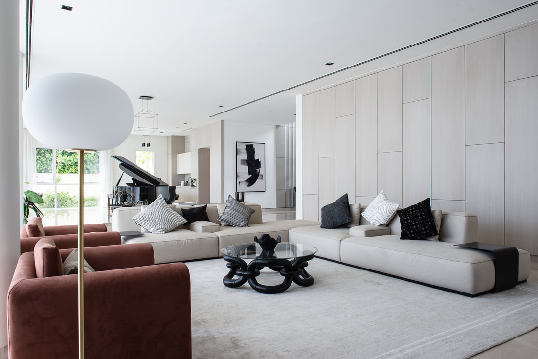 Villa living room interior design in Dubai with full-height pale timber panelling and modular seating